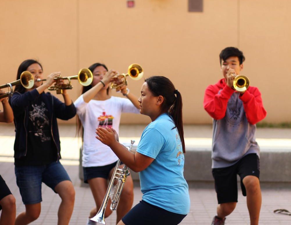 Junior and trumpet section leader Justine Sato guides her classmates through a trumpet routine.