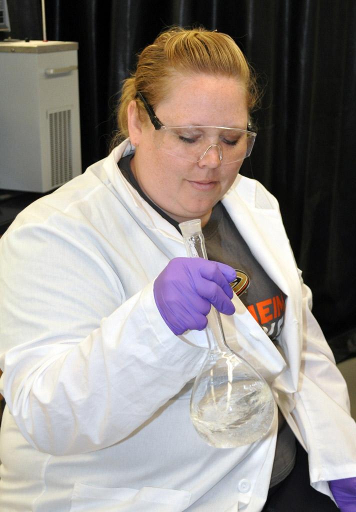 Cooper prepares a solution in order to identify the chemical structure of the evidence.