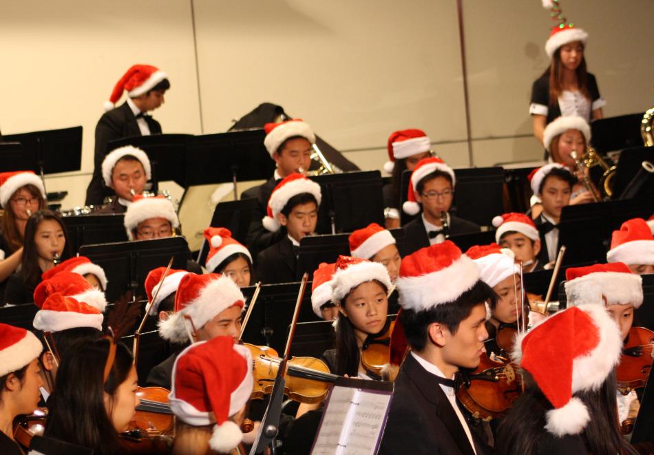 Performers at the instrumental music concert dawn their festive hats on stage.