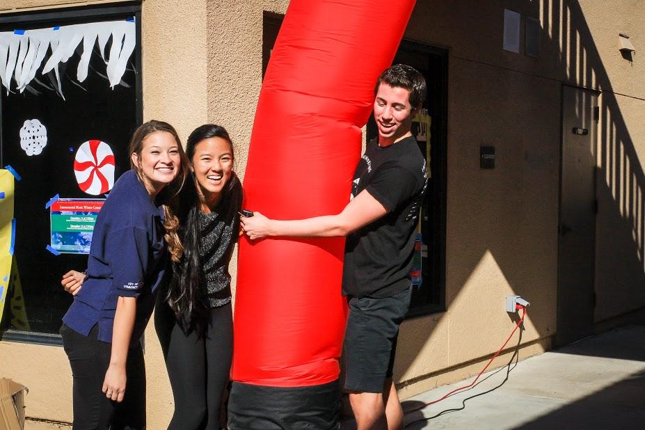 Seniors Lexi Deane, Karina Yamasaki and Nick Volucci show their excitement about Winterfest.