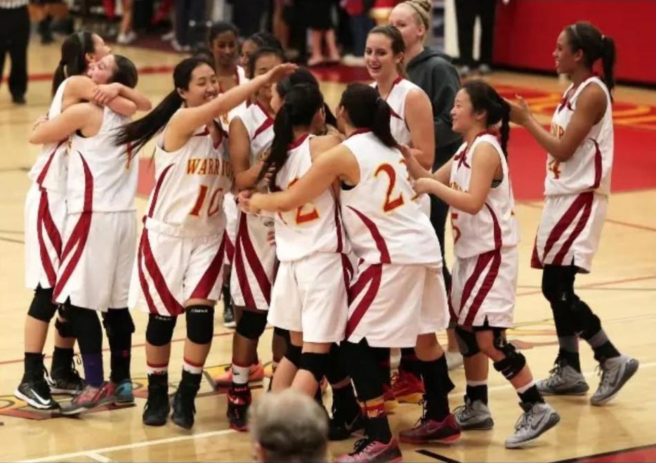 The girls basketball team rejoices together after a recent win. 
