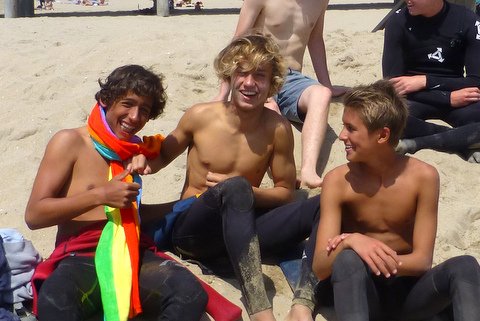 (Left to Right) Seniors Jordan Okamoto, Josh Raymond and Junior Jack Thurber kick back on the beach after a day of surfing. 