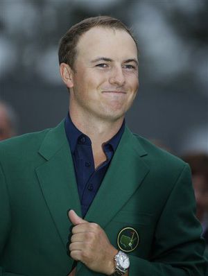2015 Masters winner Jordan Spieth celebrates by wearing the famed green jacket, given to each years champion.