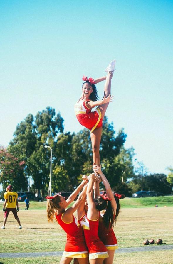 Cheer practices its routine on the field