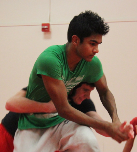 Junior captains Neil Naraj and Liam MacArthur demonstrate a body lock to their teammates in order to prepare for upcoming matches against Northwood High and Beckman High.