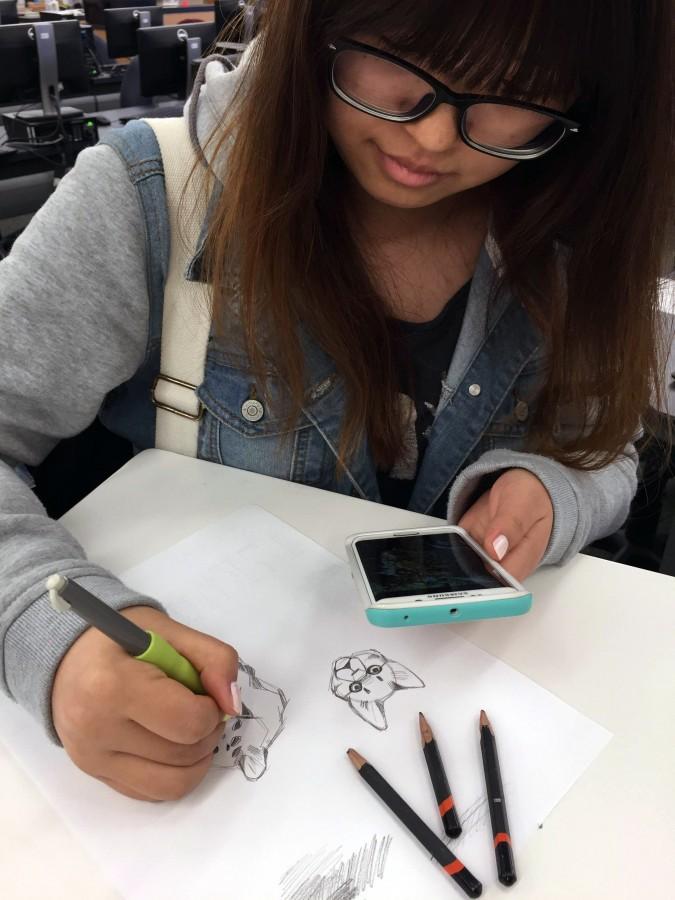 Junior Caroline Lee sketches a design that she created using software. 