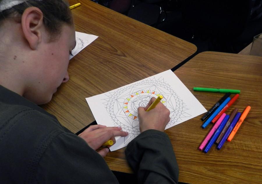 Digital Media student and freshman Christy Beutel colors a mandala in the combined class which allowed students to interact and collaborate with each other. 