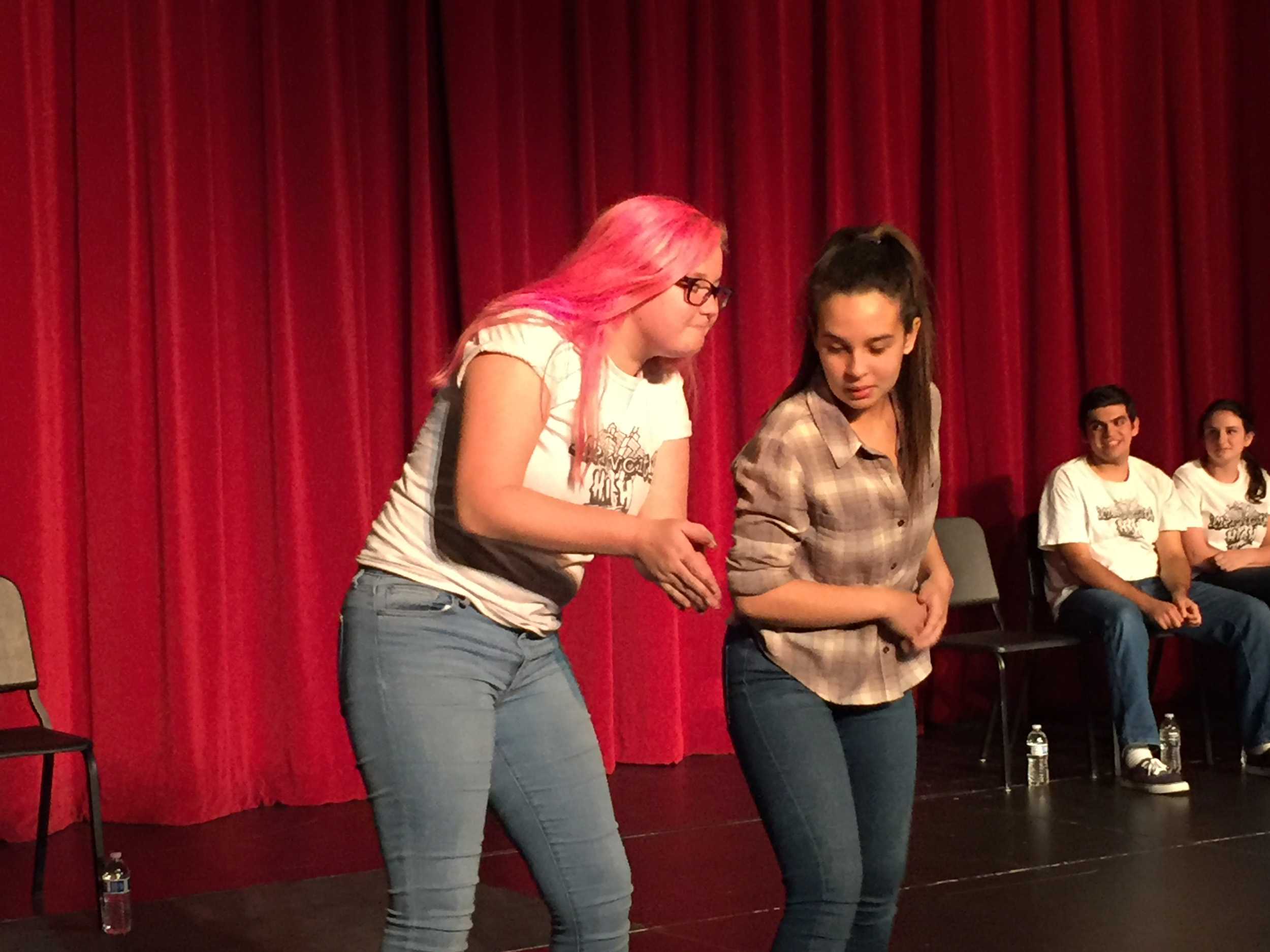 Alumni Gabi Feliciano and junior Rowan Biggs help fill the theater with laughter.