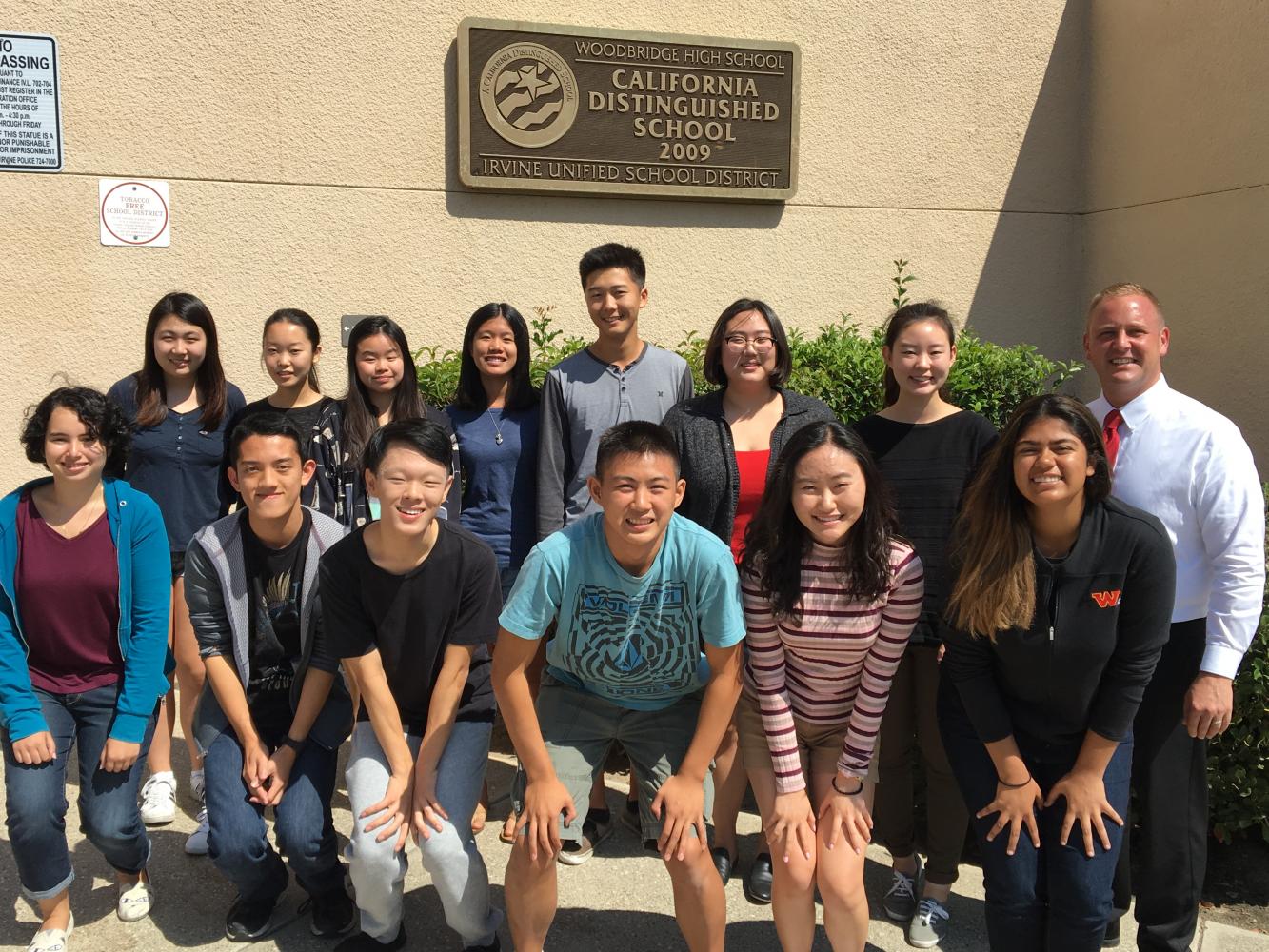 After being informed of their National Merit semifinalist status, the honored Warriors pose for a picture with principal Chistopher Krebs.