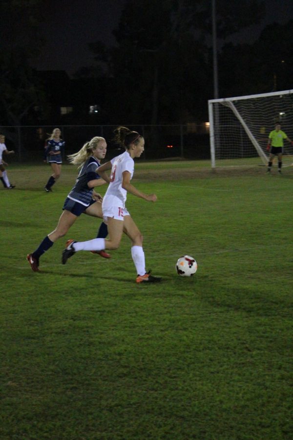 Sophomore Hannah Cooper gains control of the ball and runs towards the goal.