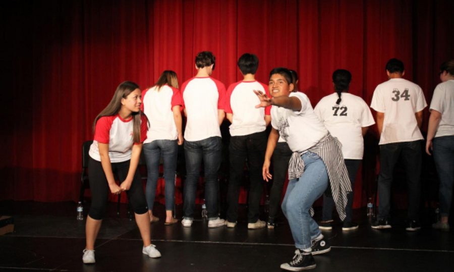ImprovCity High members compete in a game on stage.  