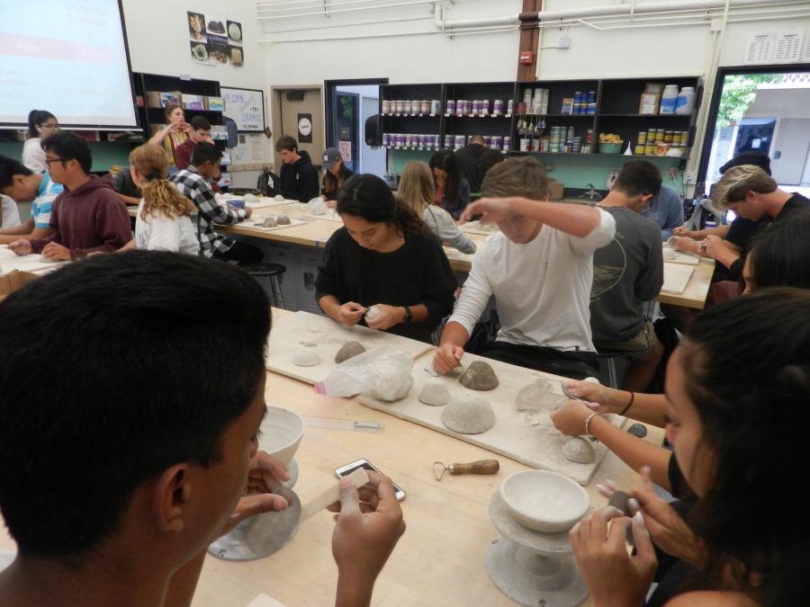 Students in ceramics carefully craft their art.