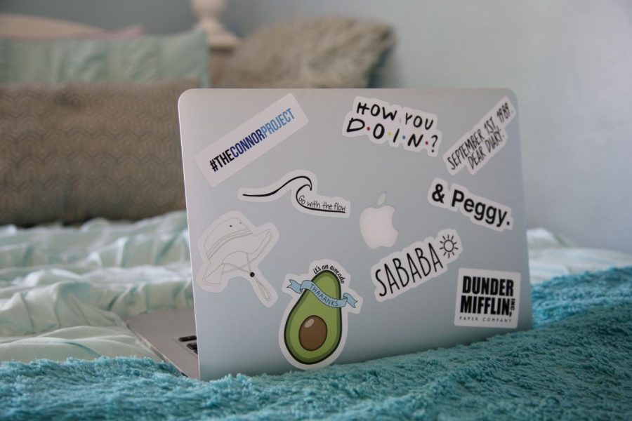 The laptop is decorated with a variety of designs from Redbubble.
