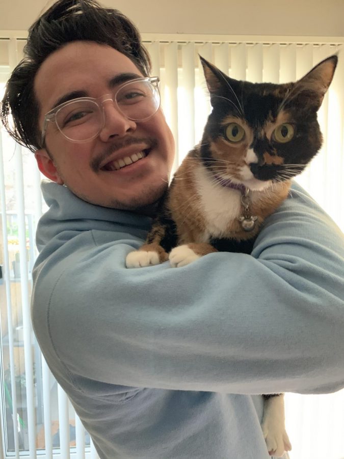 Science teacher Will Buckley with his cat Autumn, just one of many pets teachers own. 
