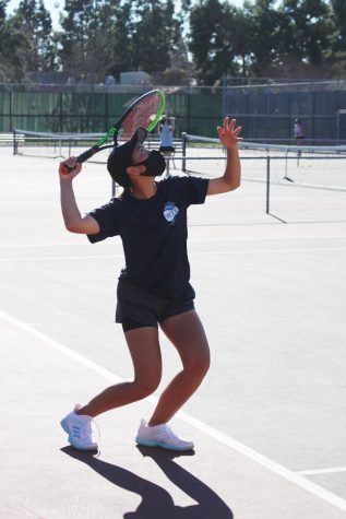 Girls varsity tennis practice serves to prepare for their long awaited season