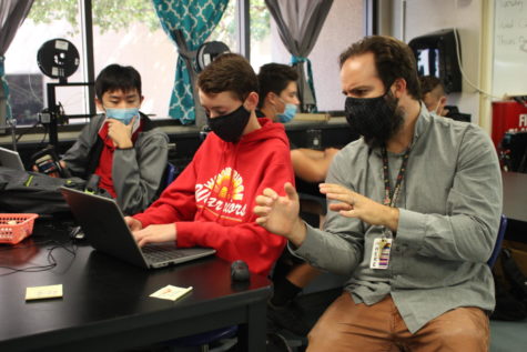 Science teacher Daniel Pilchman works with students on a 3D printing assignment 
