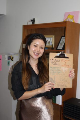 Tuyen Bui shows her clipboard that she has kept since high school from all of her prior teachers.