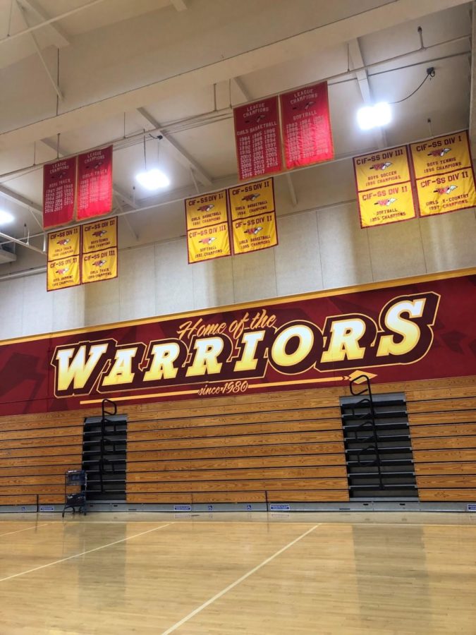 The+Woodbridge+High+gym+is+decorated+in+red+and+gold%2C+the+school+colors.+The+school+changed+its+mascot+in+2001+from+a+native+american+to+an+arrow+to+represent+a+Woodbridge+Warrior.