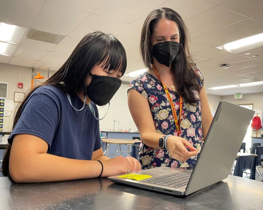Techy Teaching: Science teacher Jacklyn Severn talks to Freshman student Aanjae Yu. Gizmos and Canvas are resources that Severn worked with for teaching.
