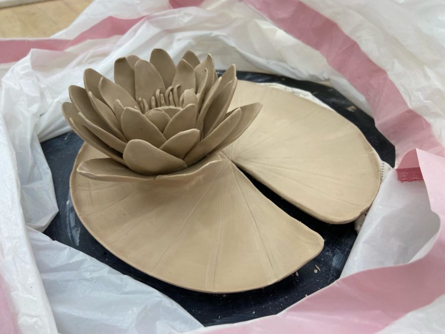 Senior Julia Cho is currently working on her flower candle holder.
