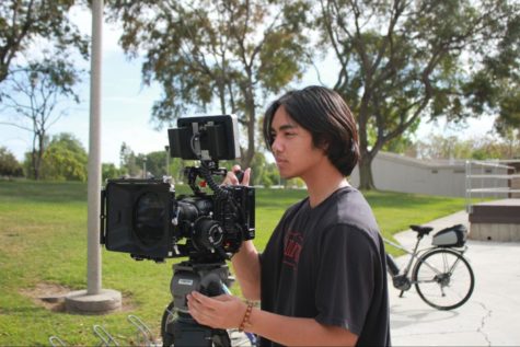 Jake Sanjongco, the Media Commissioner for Warrior TV,  adjusts the camera while filming one of the short films.

