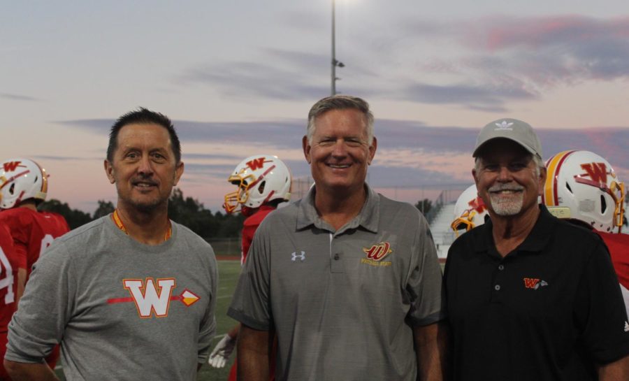 Coaches Don Grable, Rick Gibson and Eric Bangs
pose for a photo at the homecoming football game;

all three came out of retirement to support Wood-
bridge Highs football team.