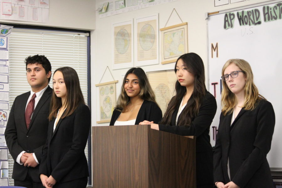 Mock trial members Arman Nemati, Natalie Miller, Ashna Parekh, Siyun Ke and Kailey Moore (left to right) stand up to introduce their opening statement during a practice session at Woodbridge High.