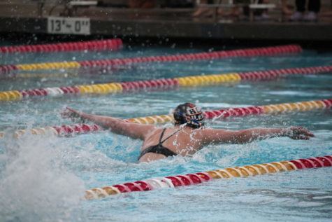 Woodbridge High swim team athlete speeds past opponents during the butterfly stroke.
