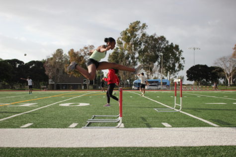 Freshman Garryn Forde takes large leaps over the hurdles
during after school track practice.