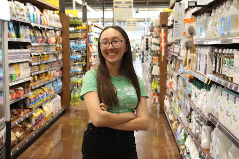 Junior Esther Bristol happily smiles to greet customers in her workplace, Whole Foods Market. 