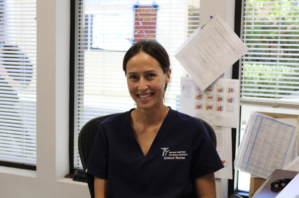 School nurse Felicia Reinert, a new staff member, smiles at her desk.