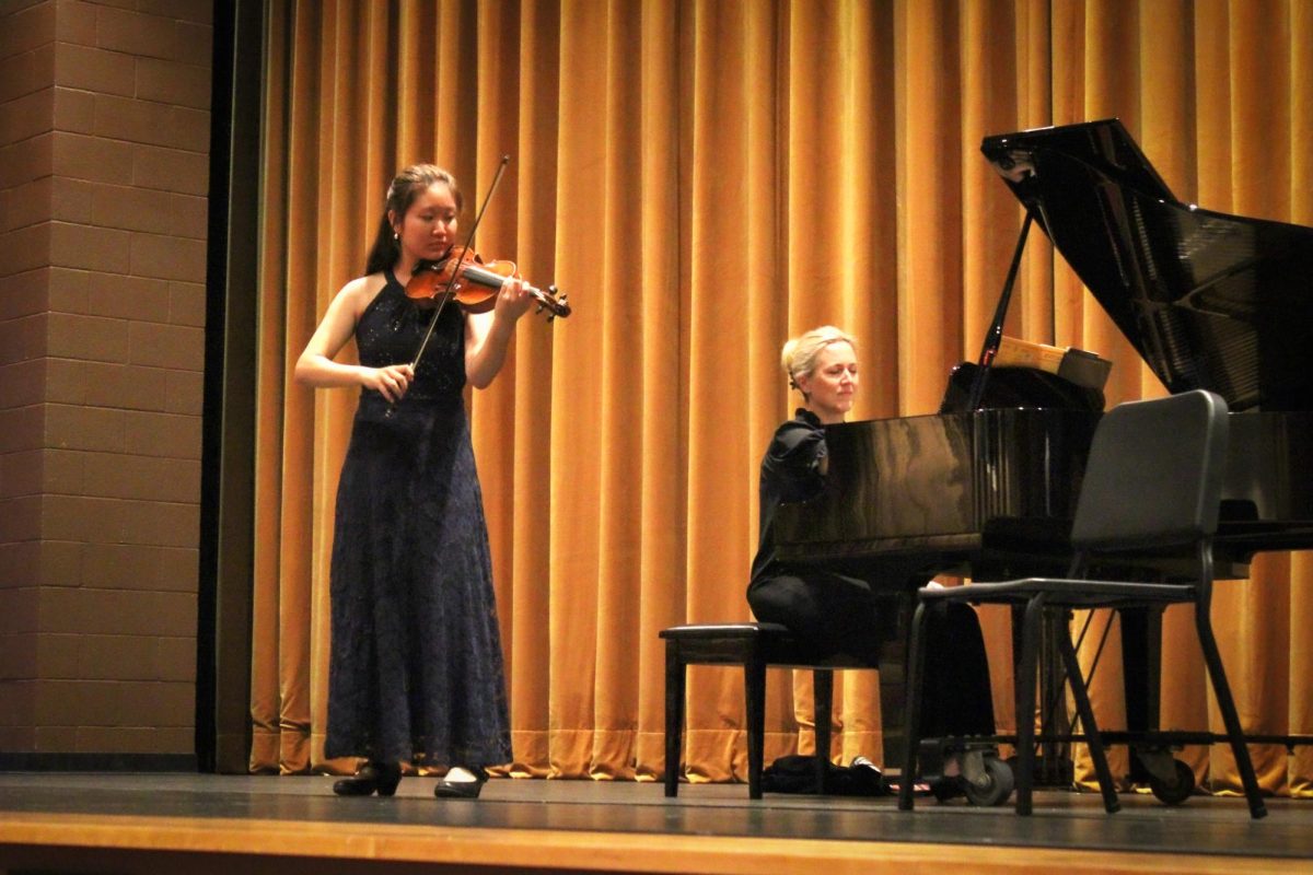 Senior Yuri Yaguchi rehearses her solo with the pianist before the performance.