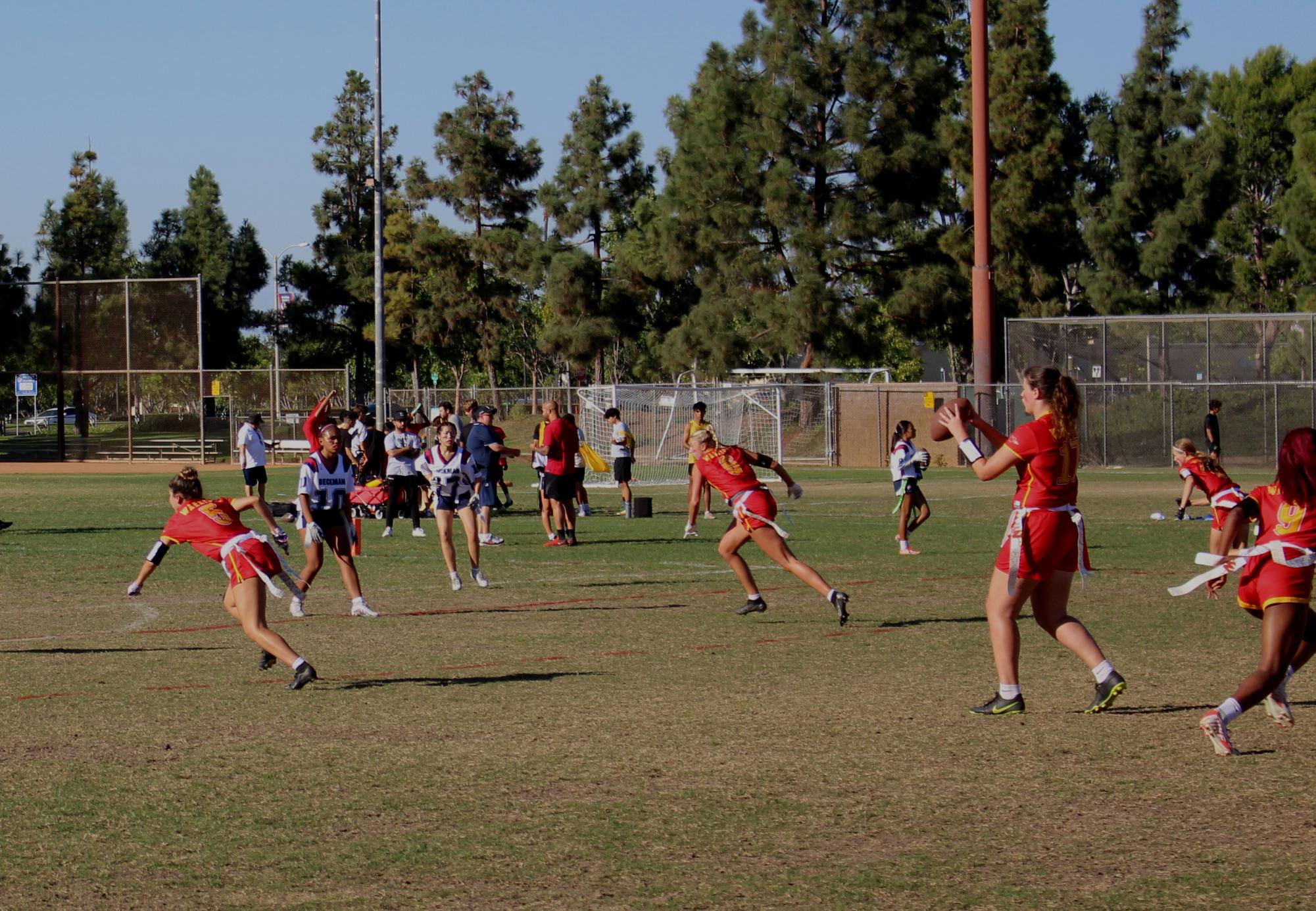 The varsity girls’ flag football team makes their way towards the opposing team’s end zone.