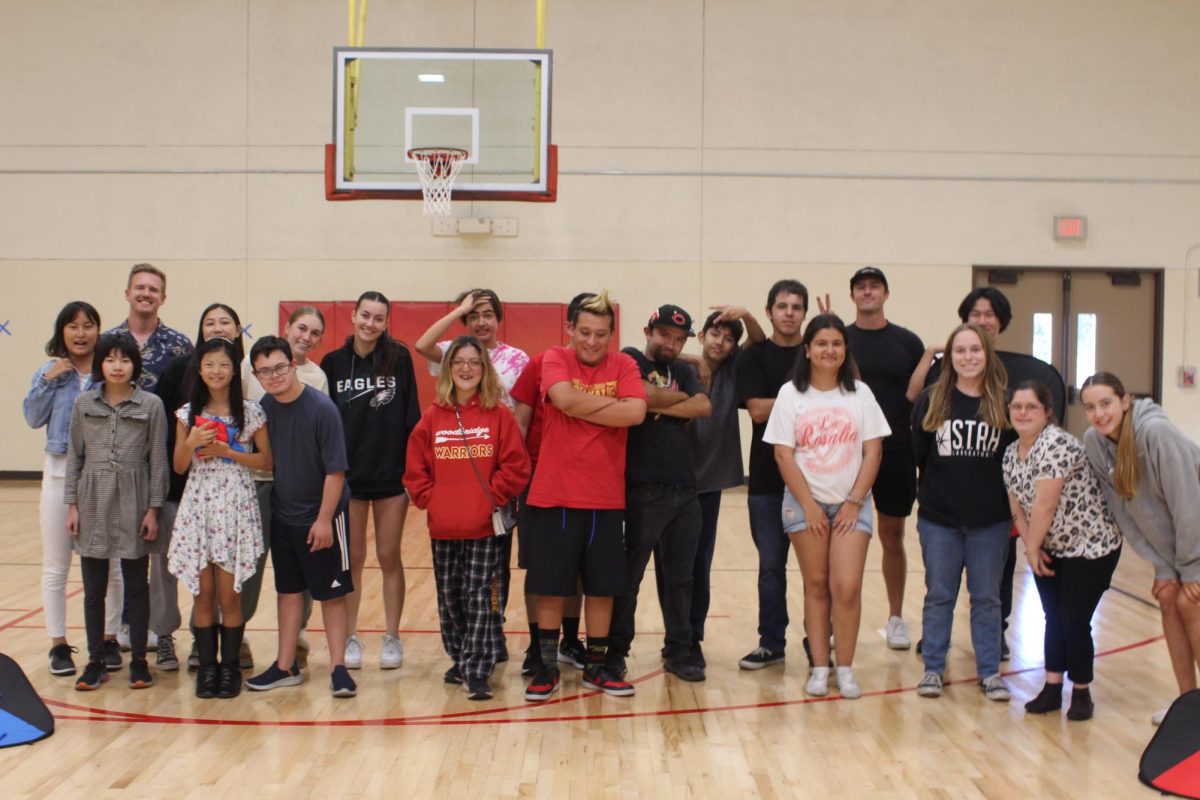 Unified Sports members and volunteers gather together at a club meeting.
