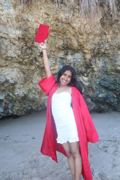 Sriram poses holding her cap and gown, in anticipation for graduation. 