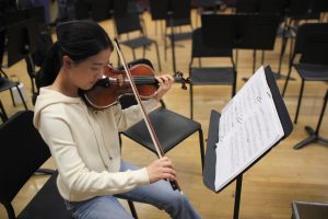 Junior Yuna Noh practices playing her violin.
