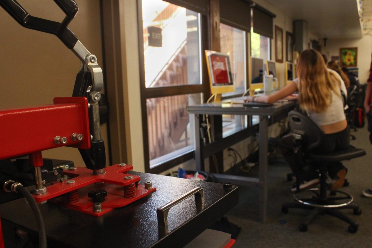 The class’s press for imprinting designs sits in the corner.
