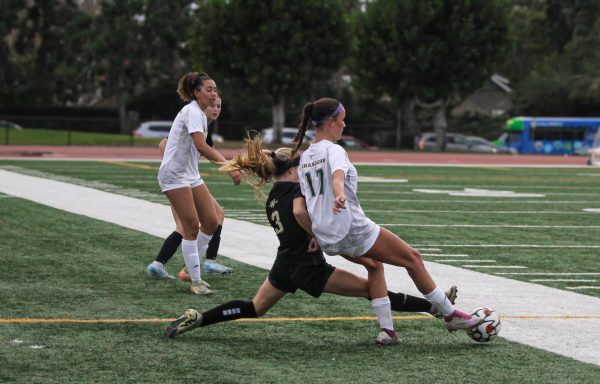 Sophomore Dyllan Harris slides for the ball in a soccer game against Edison High School.