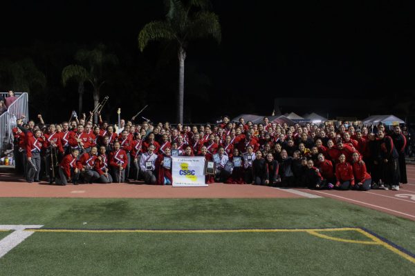 Woodbridge High's Entertainment Corps pose with their first place banner.