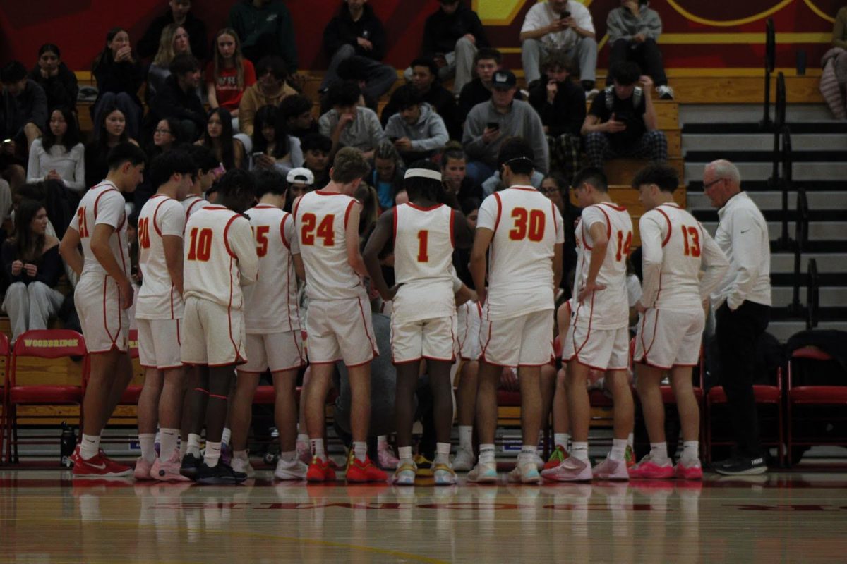 Woodbridge High varsity basketball team in a huddle before a game. 