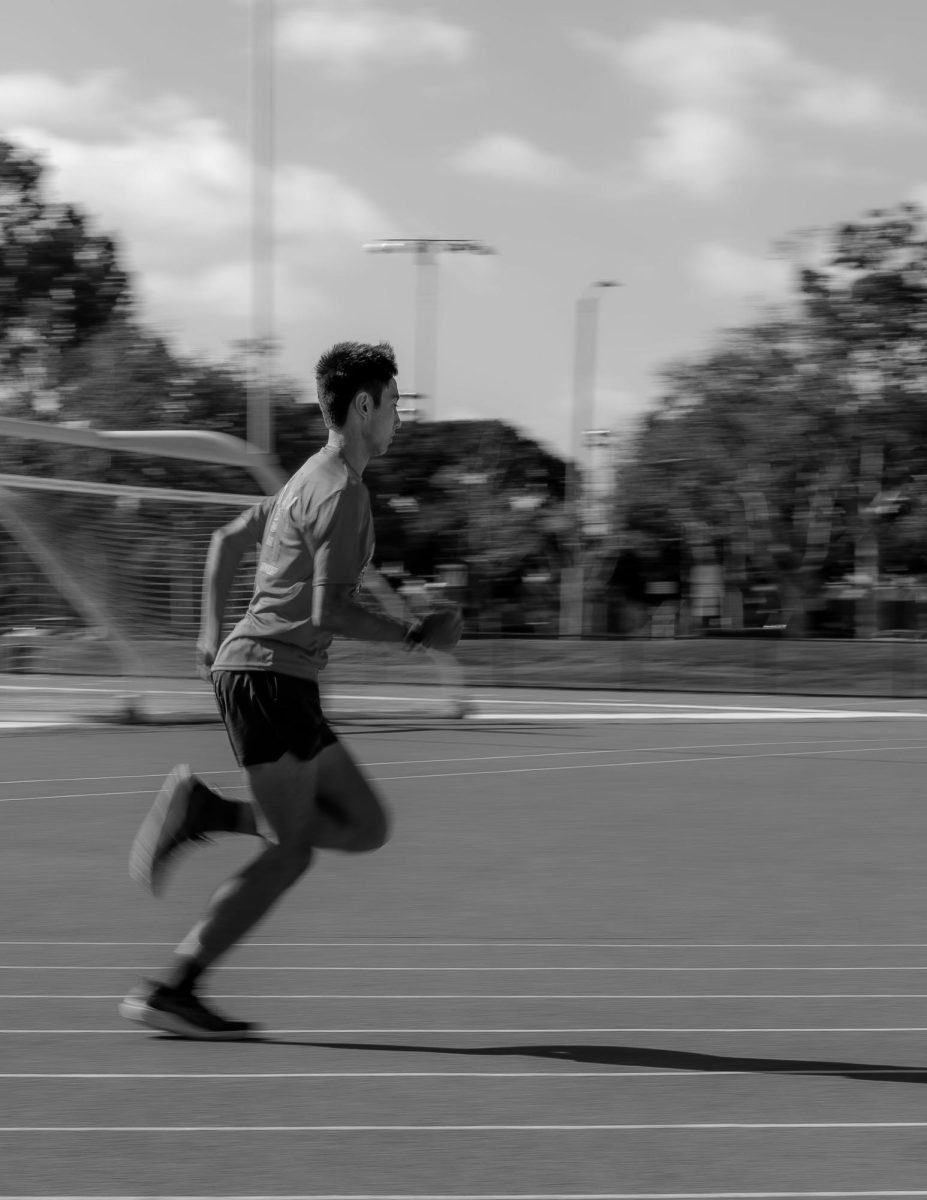  Aiden Antonio running on the track at Woodbridge High.