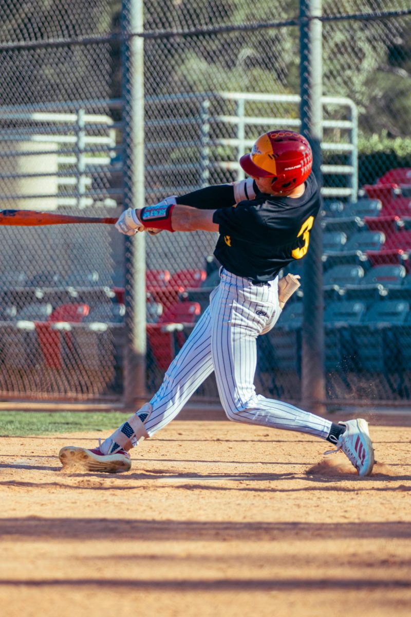 Vincent DeMarco hits the baseball pitched to him 
during a game.